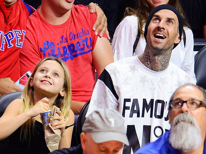 Travis Barker (R) and his daughter Alabama Barker attend a basketball game between the Orlando Magic and the Los Angeles Clippers at Staples Center on December 3, 2014 in Los Angeles, California. (Photo by Noel Vasquez/GC