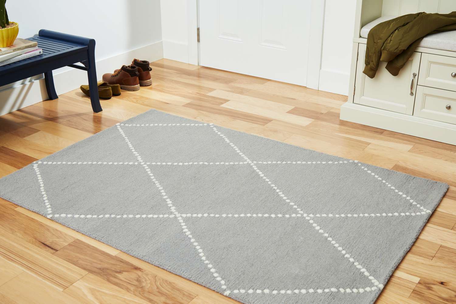 The Rugs USA Dotted Diamond Trellis Nursery Area Rug on a wooden floor