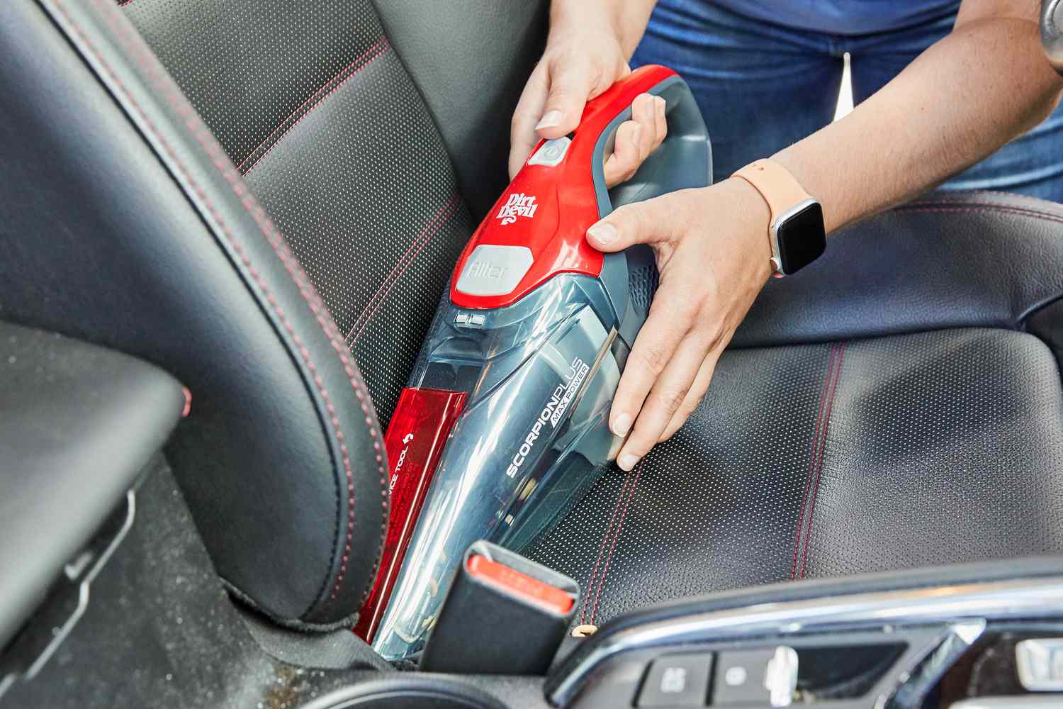 Person using Dirt Devil SD30025B Scorpion Plus Corded Handheld Vacuum Cleaner to clean car seat
