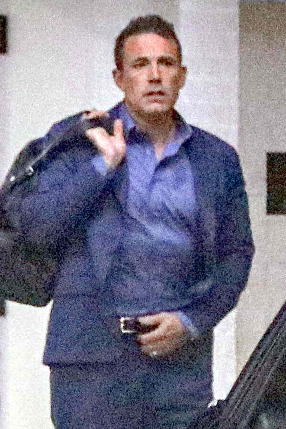 Is Jennifer Lopez still calling the shots for Ben Affleck? The actor looks super stressed as he arrives at his office wearing his wedding band after making the controversial decision to ditch it yesterday afternoon. Reports have surfaced that even though his marriage to Jennifer Lopez is officially over, she is demanding he wears the ring until the divorce is final.