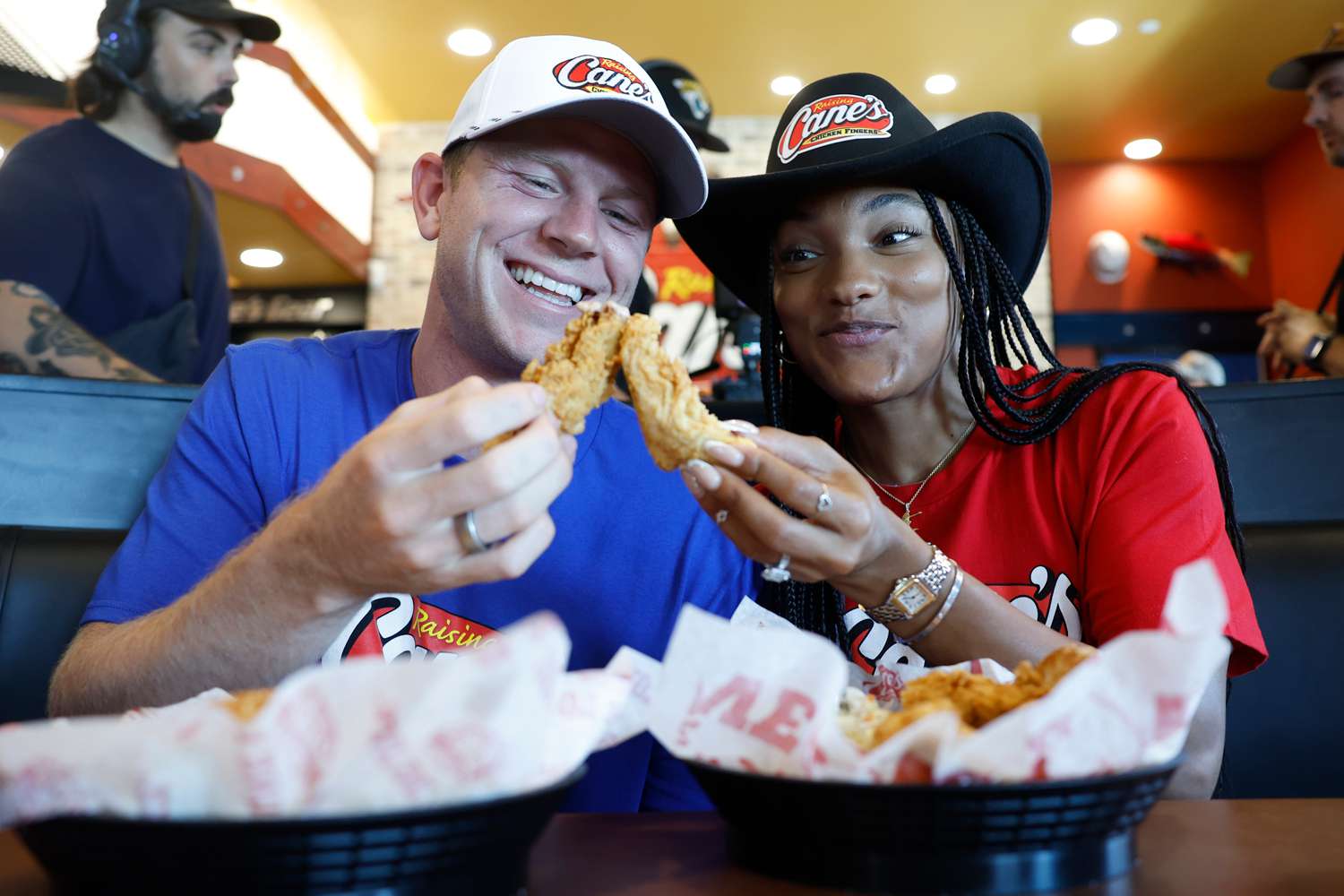 Paralympian Hunter Woodhall and Olympian Tara Davis-Woodhall enjoy the break after working Pre-Paris "Shift" at Raising Cane's on July 10, 2024 in Fayetteville, 