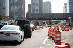 Vehicles approach the Holland Tunnel in Jersey City, New Jersey, US, on Wednesday, July 26, 2023. New York's plan to charge drivers entering midtown Manhattan is a brazen money grab, New Jersey's senior US senator said after the Garden State sued to block the congestion pricing proposal. 