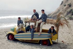 band "The Beach Boys" pose for a portrait with a vintage station wagon in August 1962