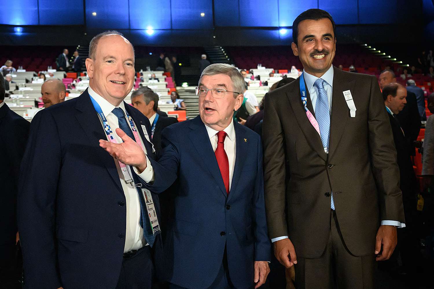 International Olympic Committe (IOC) President Thomas Bach (C) gestures between IOC members Prince Albert II of Monaco (L) and Sheikh Tamim bin Hamad al-Thani, Emir of Quatar, on the first day of the 142nd IOC Session, three days ahead of the start of the Paris 2024 Olympic Games, in Paris on July 23, 2024.