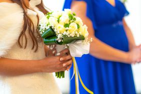 Detail of a bride holding a bouquet of flowers at the wedding, marriage portraits