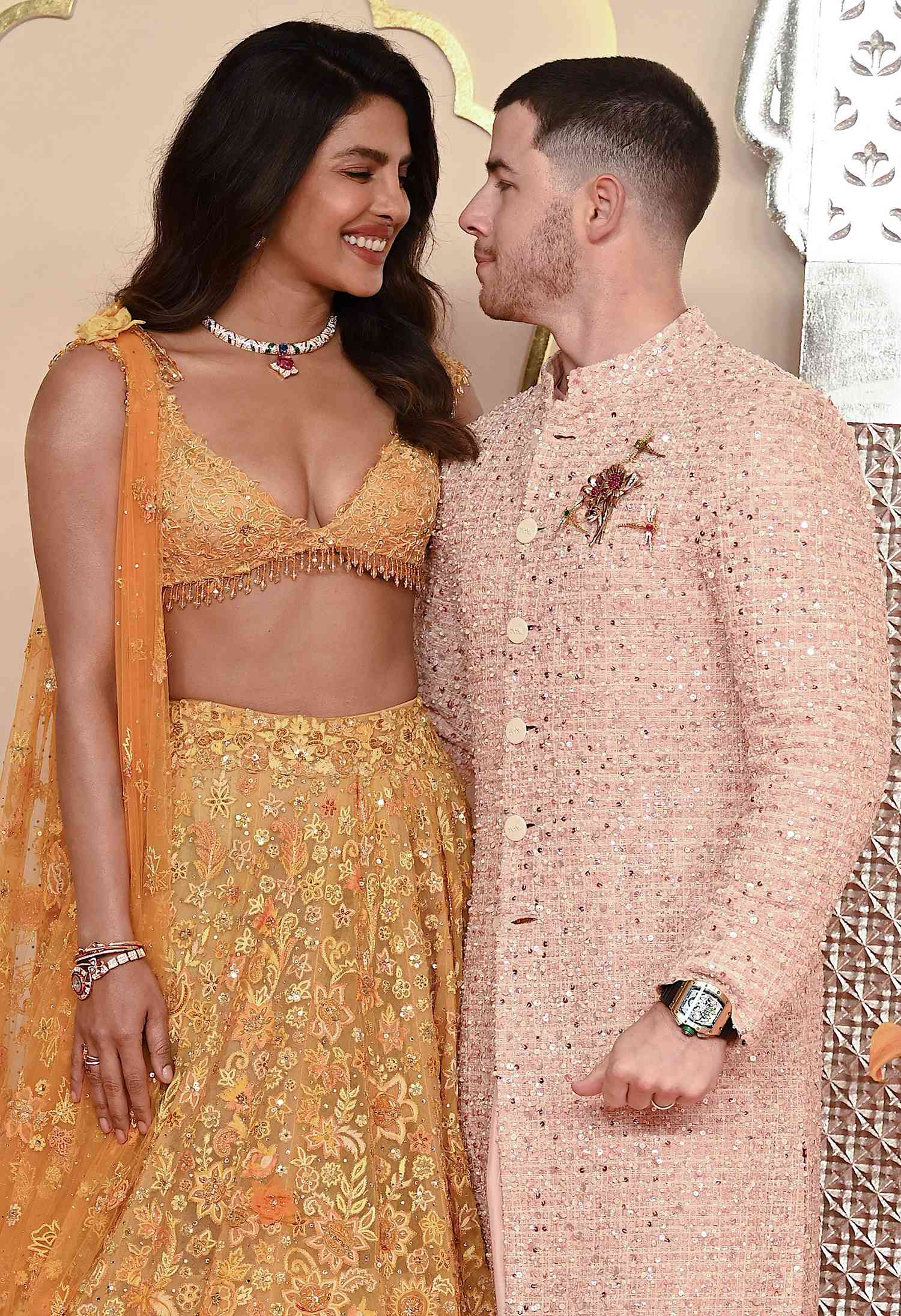 Priyanka Chopra Jonas (L) and her husband American singer-songwriter and actor Nick Jonas (R) pose for photos as they arrive to attend the wedding ceremony of billionaire tycoon and Chairman of Reliance Industries Mukesh Ambani's son Anant Ambani and Radhika Merchant in Mumbai on July 12, 2024.