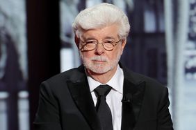 George Lucas arrives onstage to accept the Honorary Palme
