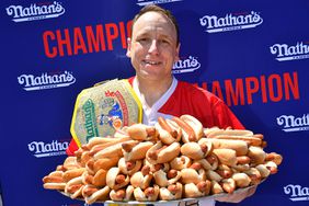 Joey Chestnut eats 63 hot dogs and buns in 10 minutes and Miki Sudo eats 40 hot dogs and buns in 10 minutes to win the 2022 Nathans Famous Fourth of July International Hot Dog Eating Contest at Coney Island on July 04, 2022 in New York.