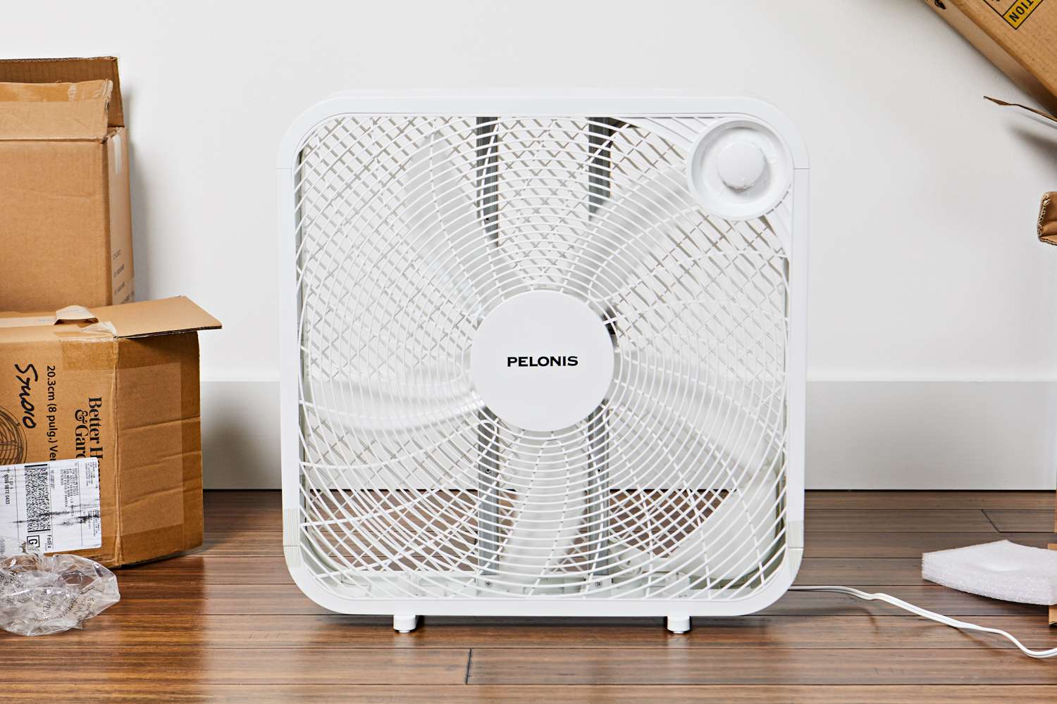 Pelonis 3-Speed Box Fan displayed on a wood floor