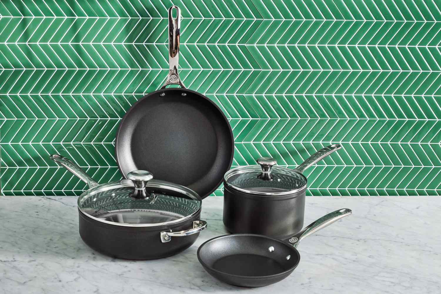 Le Creuset Toughened Nonstick PRO Cookware Set, 6 pc. on a tiled green background and a marble counter