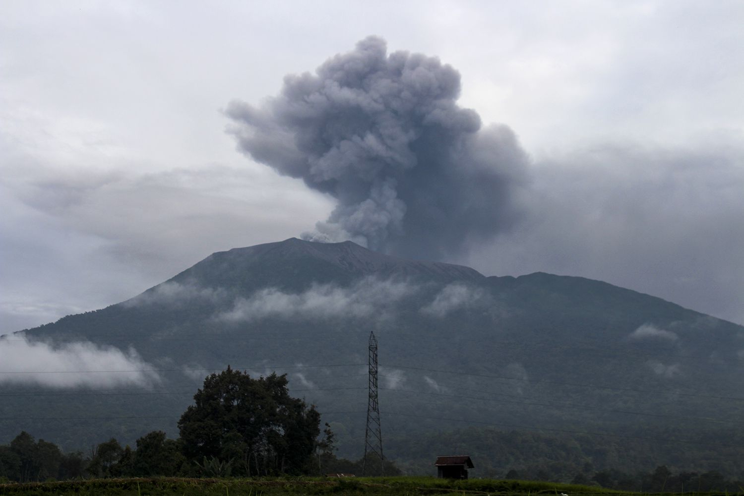 Volcanic ash spews from Mount Marapi during an eruption as seen from Batu Palano village in Agam