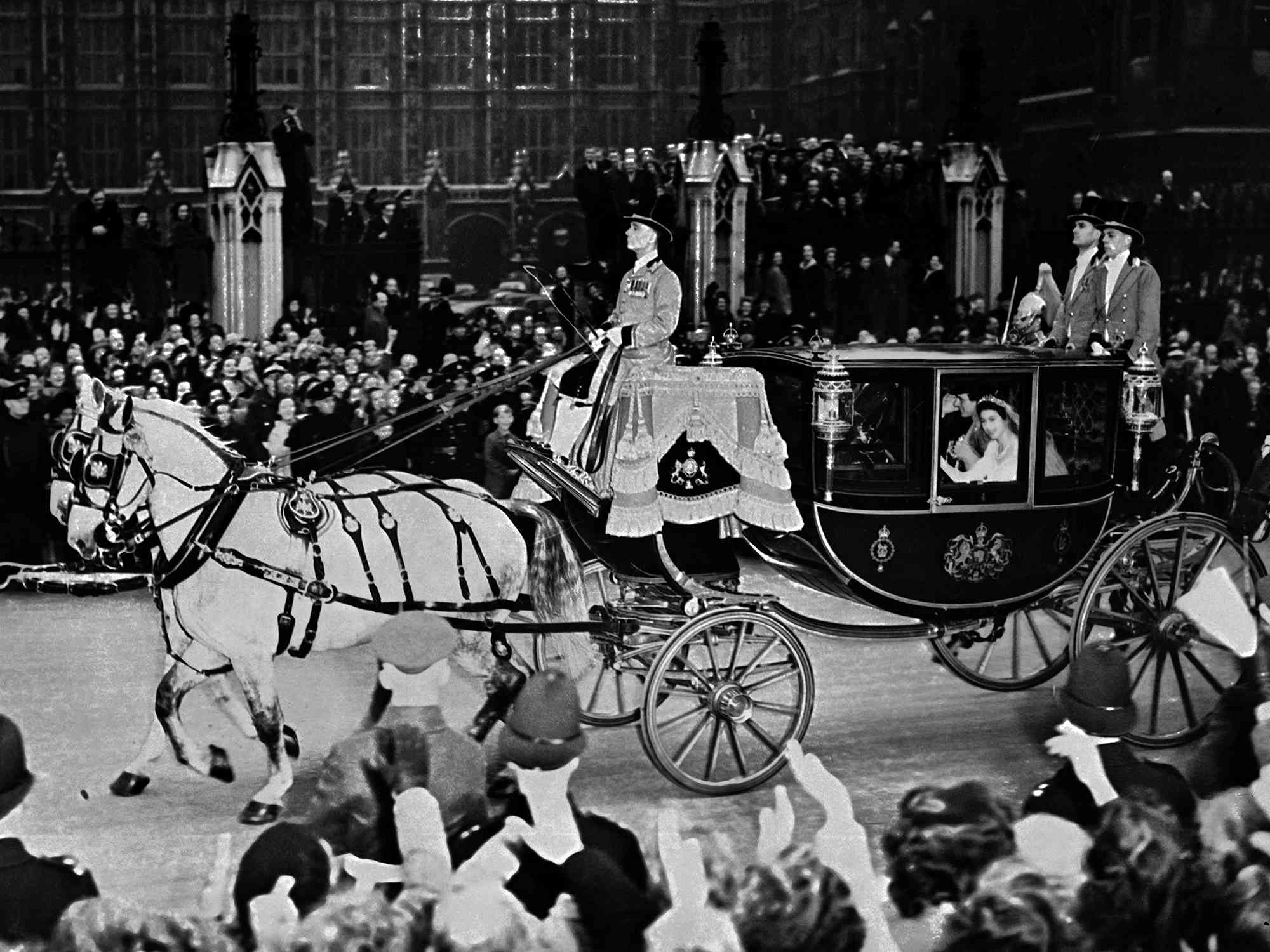 Queen Elizabeth II (in coach) and her husband Prince Philip, Duke of Edinburgh are cheered by the crowd after their wedding ceremony, on November 20, 1947, on their road to Buckingham Palace, London