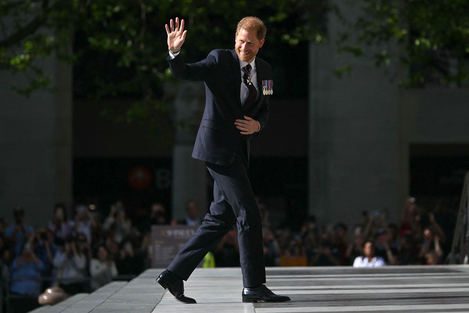 Britain's Prince Harry, Duke of Sussex waves as he arrives to attend a ceremony marking the 10th anniversary of the Invictus Games, at St Paul's Cathedral in central London, on May 8, 2024