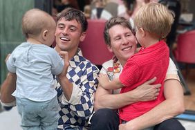 Dustin Lance Black poses with husband Tom Daley and children