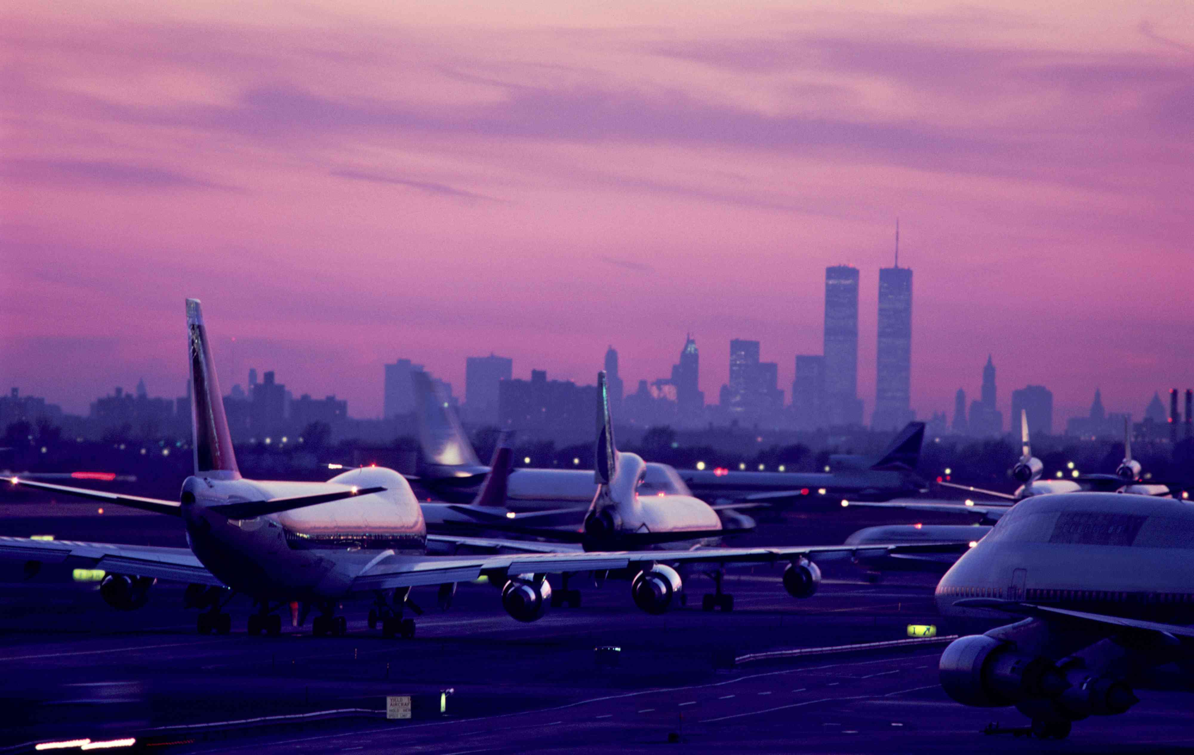 USA, New York City, JFK Airport, aircraft taxiing at sunset