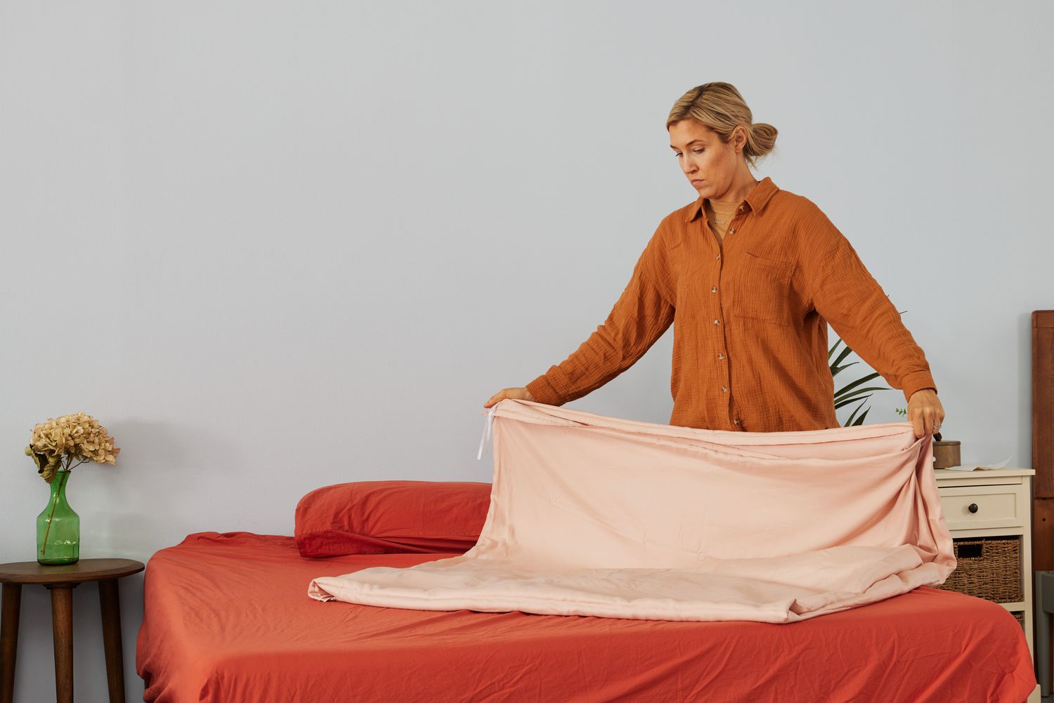 A person folding the Eucalypso Heavenly Duvet Cover