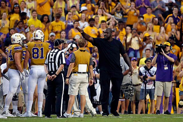 Former NBA great Shaquille O'Neal acknowledges the crowd in the first half of an NCAA college football game