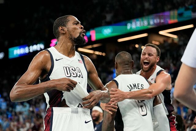 United States' Kevin Durant (7), LeBron James (6) and Steph Curry (4) celebrate after beating Serbia