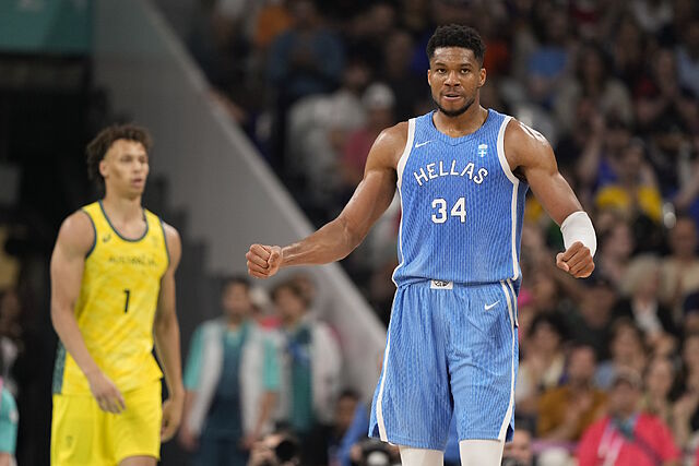 Giannis Antetokounmpo, of Greece, celebrates after a basket in front of Dyson Daniels.