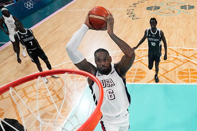 LeBron James, of the United States, goes up for a dunk against South Sudan