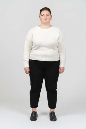 Plump woman in casual clothes standing