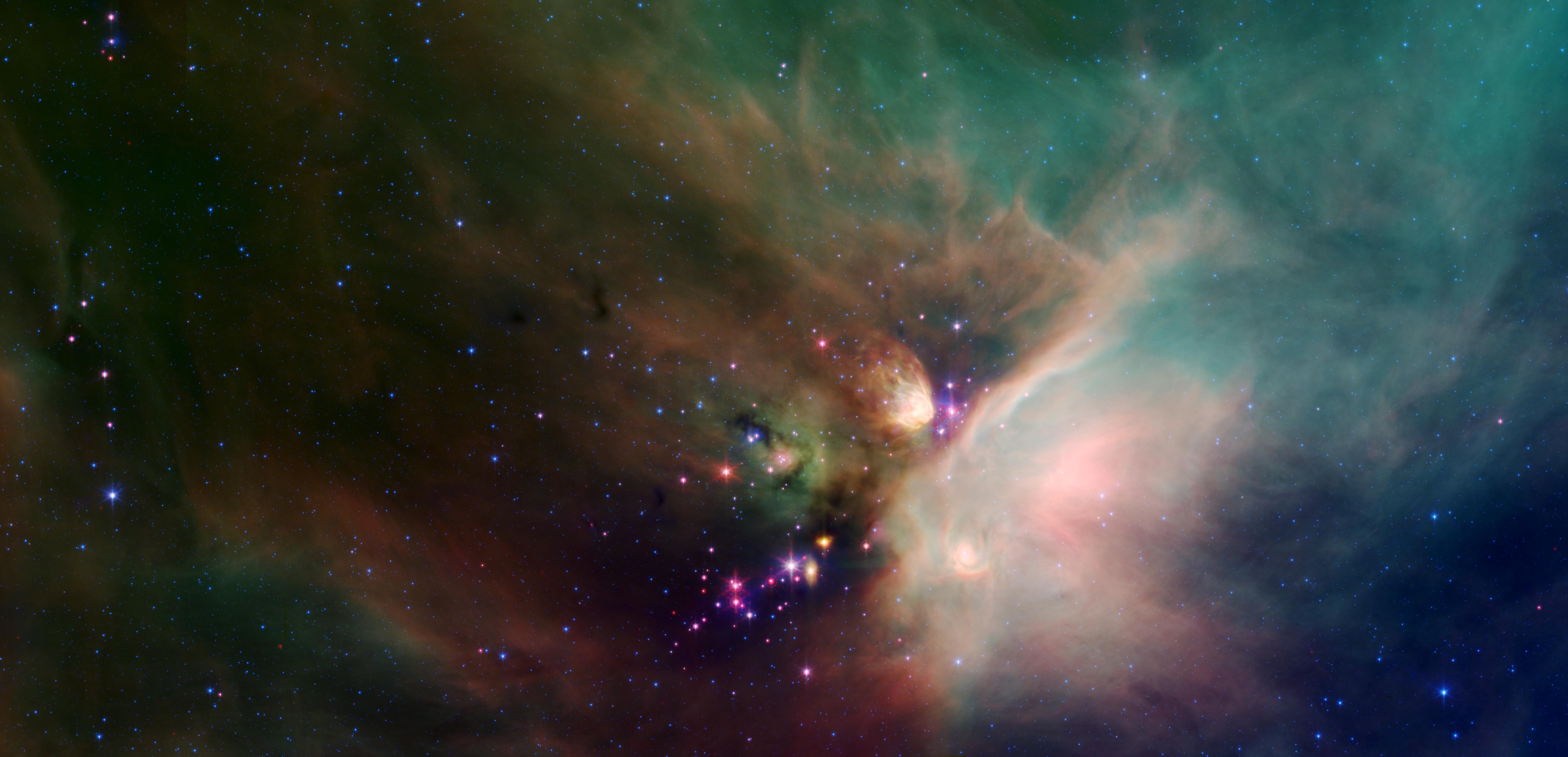 A blanket of green- and orange-colored stellar dust surrounds a grouping of purple, blue and red stars.