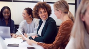 Group of multicultural women working at table