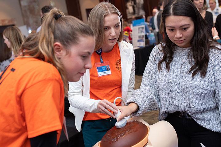 Prospective students trying a sonography demo at a Mayo Clinic career fair