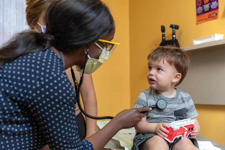 Dr. Elizabeth Ojukwu works with young patient at SEMN pediatrics