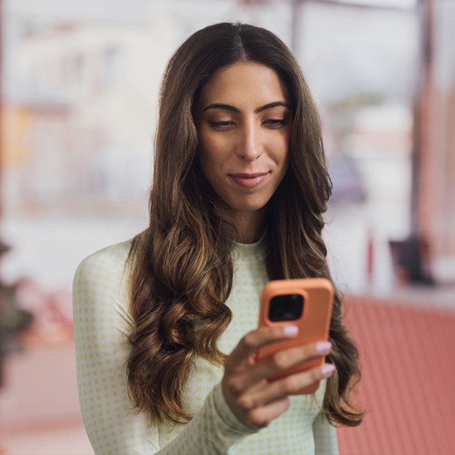 Personal trainer using a phone to keep track of business while at a gym studio.