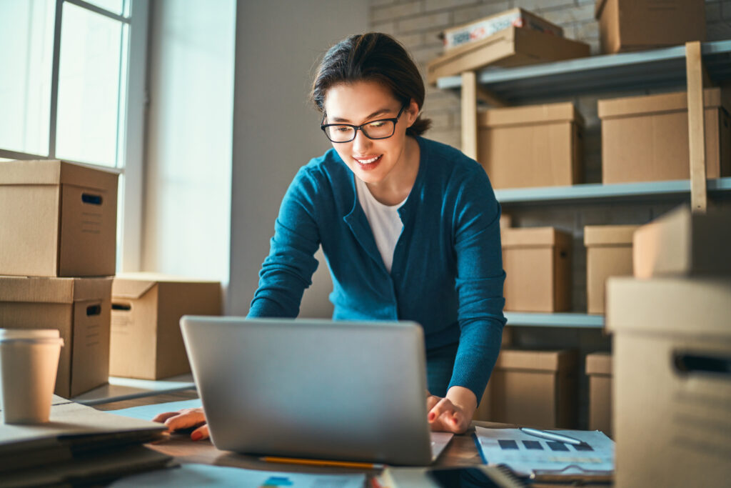 Young asian woman looking at laptop