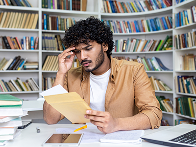 student reading rejection letter