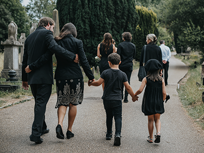 family walking in cemetary