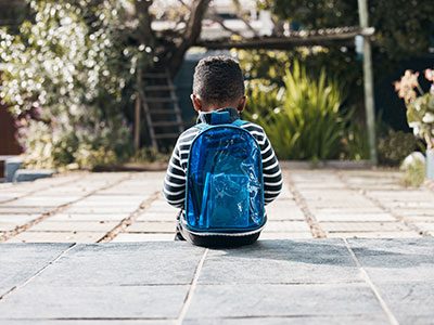 sad boy with backpack