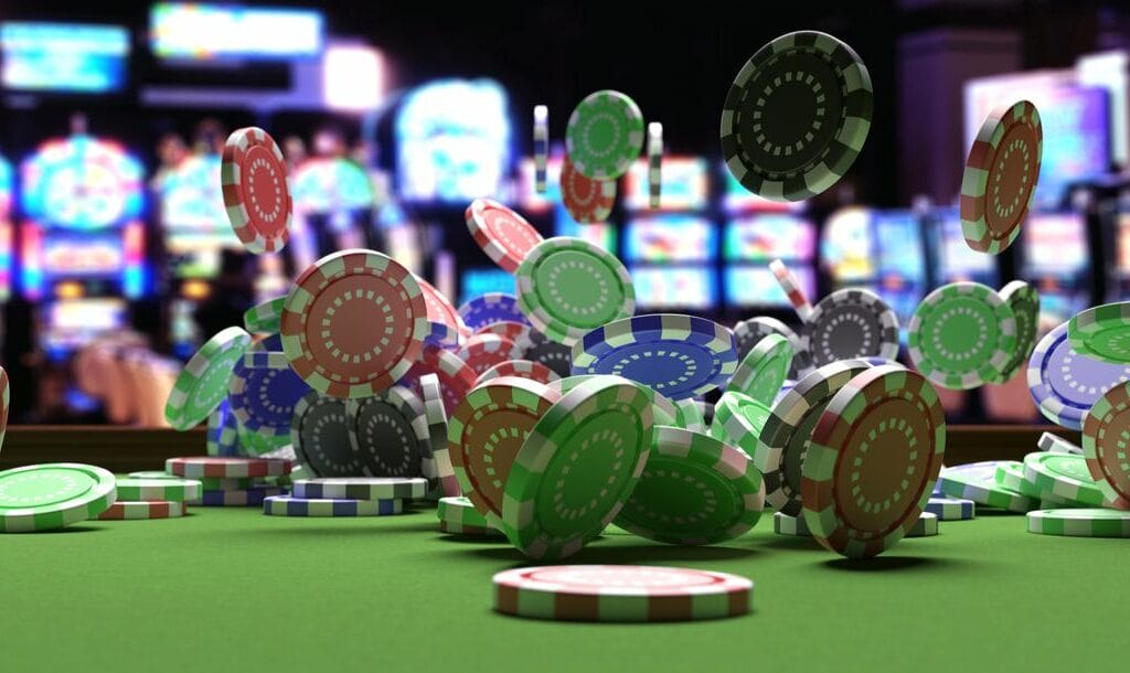 Poker chips flying around on a casino table with slot machines in the background