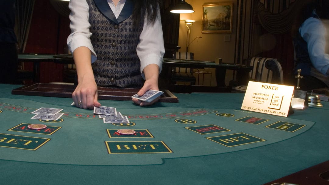 A dealer dealing out cards at a poker table.