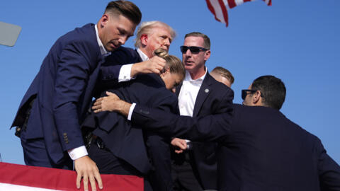Republican presidential candidate former President Donald Trump is surrounded by U.S. Secret Service agents at a campaign rally, Saturday, July 13, 2024, in Butler, Pa. 