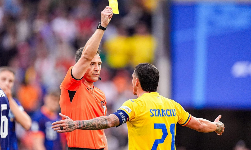 Munich, Germany. 02nd July, 2024. MUNICH, GERMANY - JULY 2: Referee Felix Zwayer shows a yellow card due to argument to Nicolae Stanciu of Romania during the Round of 16 - UEFA EURO 2024 match between Romania and Netherlands at Munich Football Arena on Ju