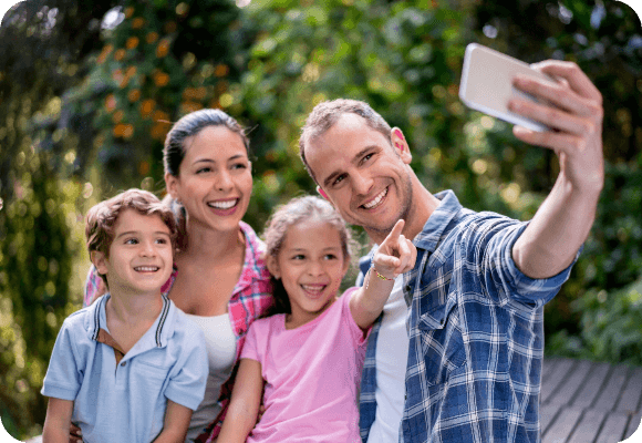 Family taking a selfie with two elementary aged kids