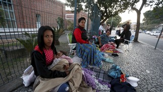 A fila se formou na noite anterior ao começo do atendimento. Muitos dormiram ao relento, incluindo crianças  — Foto: Fabiano Rocha / Agência O Globo