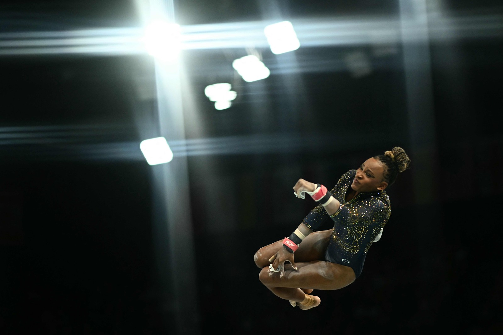 A brasileira Rebeca Andrade compete na prova de barras assimétricas da final feminina de ginástica artística por equipes — Foto: Loic VENANCE / AFP