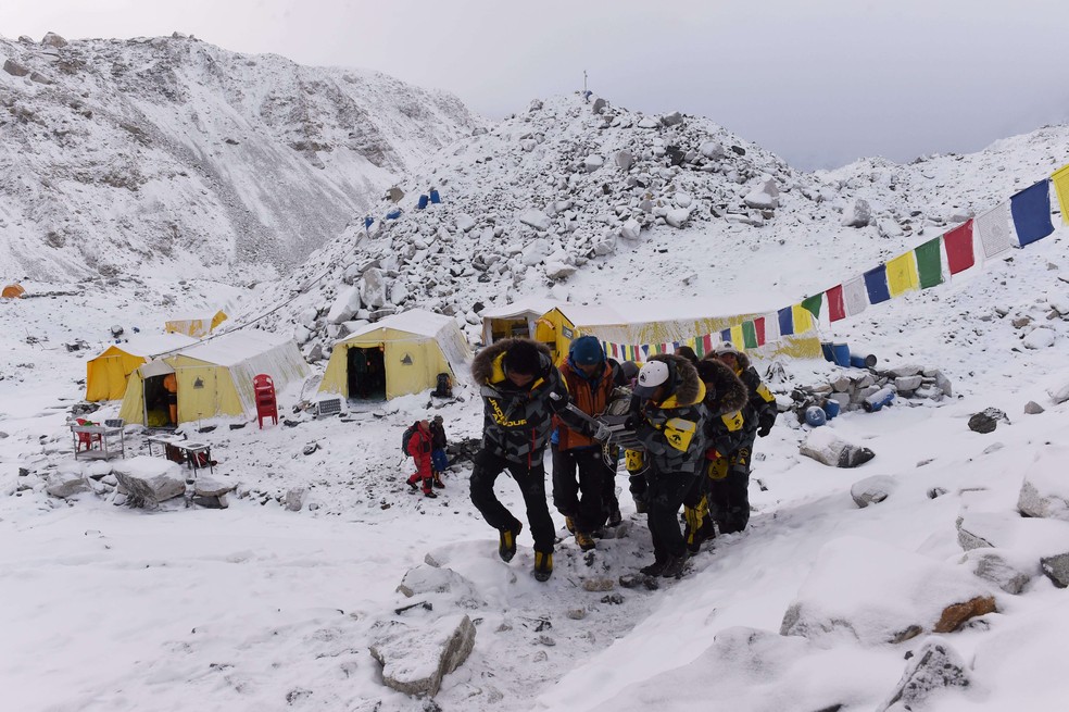 Pessoas que escalavam o Everest precisaram ser resgatadas às pressas após o terremoto no Nepal provocar uma avalanche na região — Foto: ROBERTO SCHMIDT/AFP