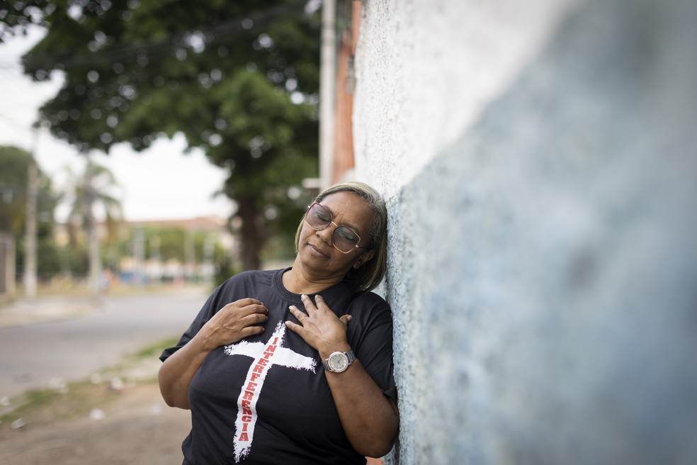 Vera Lúcia, que perdeu oito parentes na Chacina de Vigário Geral, junto ao muro que divide da linha do trem da comunidade — Foto: Márcia Foletto / Agência O Globo