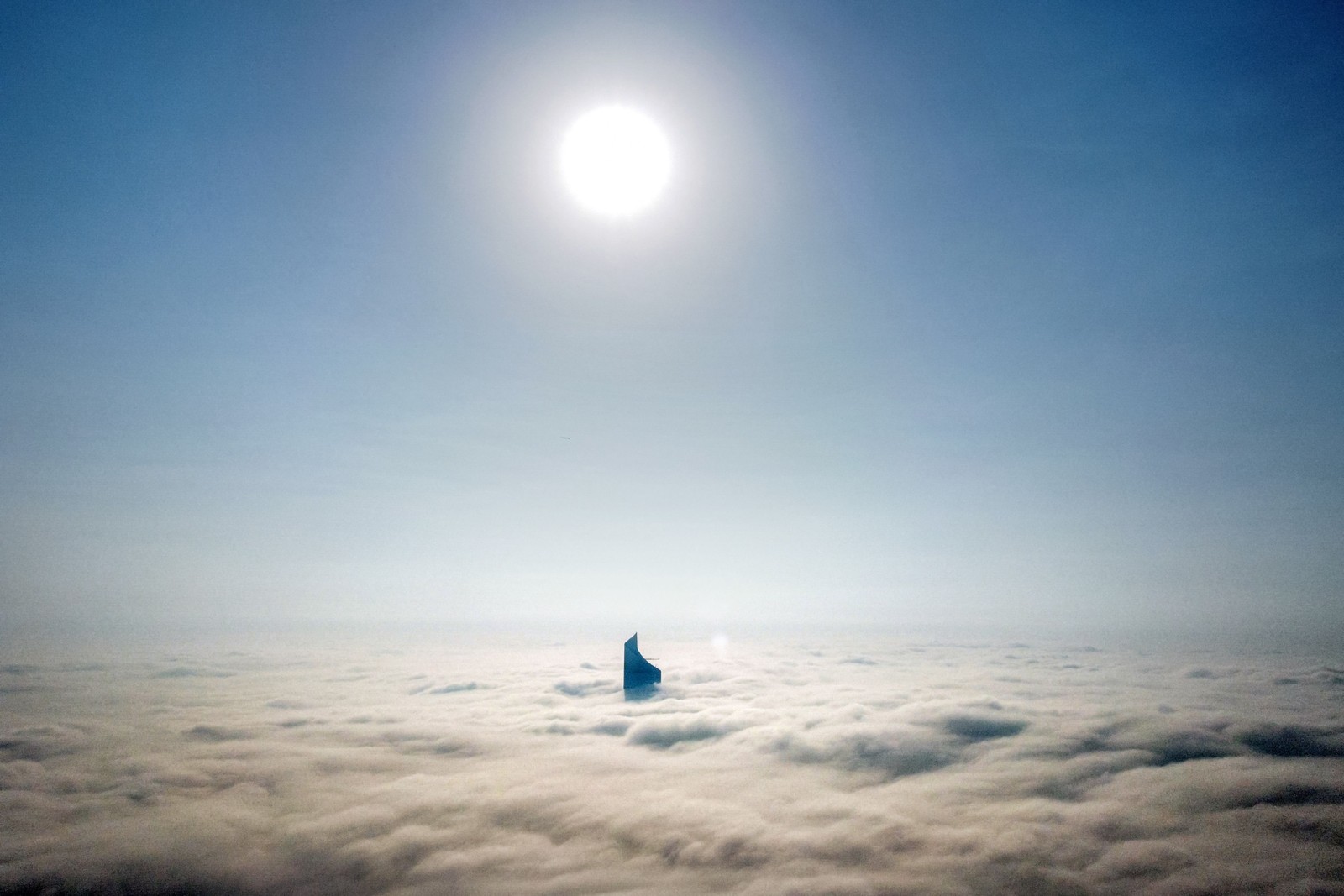 Topo da torre al-Hamra é visto atravessando forte nevoeiro que paira sobre a cidade do Kuwait — Foto: YASSER AL-ZAYYAT/AFP