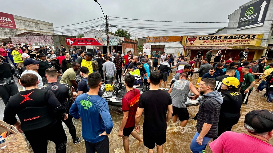 Canoas, município do Rio Grande do Sul, com equipes de resgate e voluntários ajudando vítimas de enchentes.
