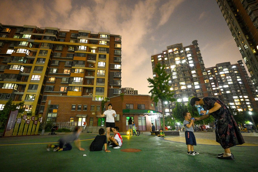 Crianças brincam em complexo residencial em Pequim — Foto: Noel Celis / AFP