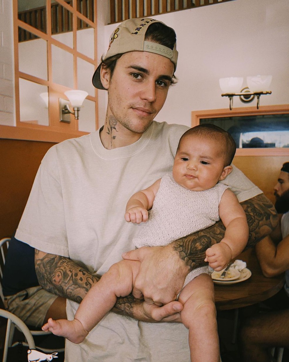 Sem barba, Justin Biber posa com bebê — Foto: @justinbieber no Instagram