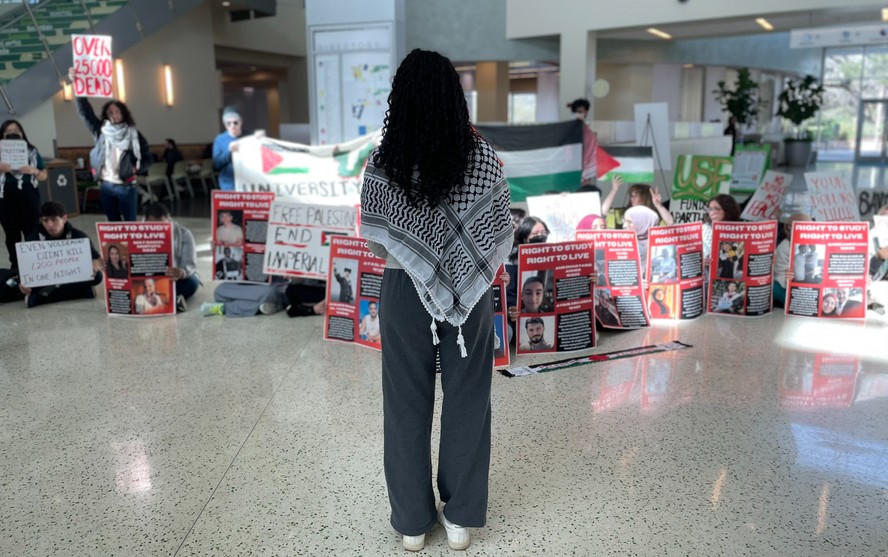 Sana (nome fictício) de frente para um protesto de estudantes pró-Palestina na Universidade do Sul da Flórida, em Tampa