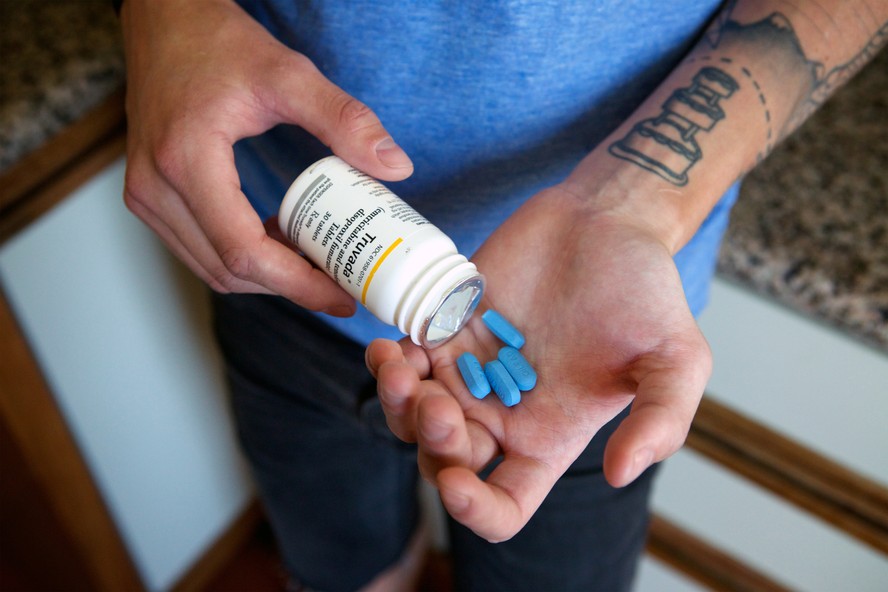 Paciente mostra comprimidos do PrEP, medicamento que protege contra a infecção pelo HIV.