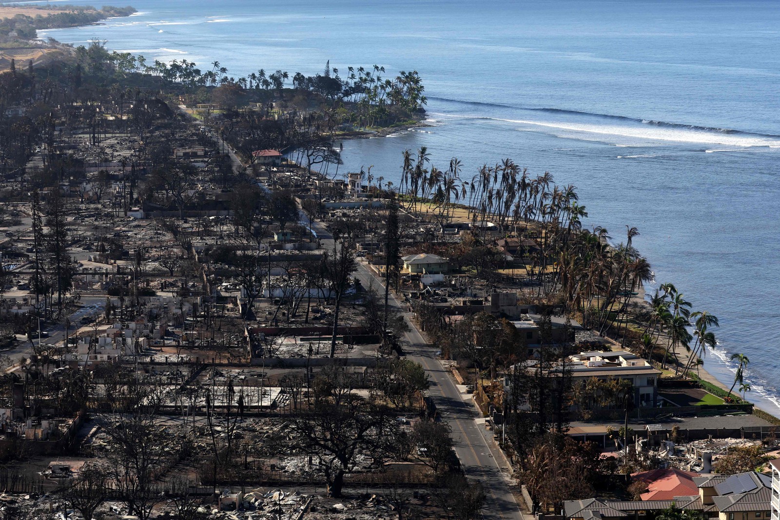 O incêndio chegou até a praia de Lahaina, Havaí. Moradores e turistas se jogaram no mar para se proteger do fogo. — Foto: Justin Sullivan/Getty Images/AFP